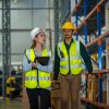 Warehouse employees with Inventory checking software in the retail warehouse.